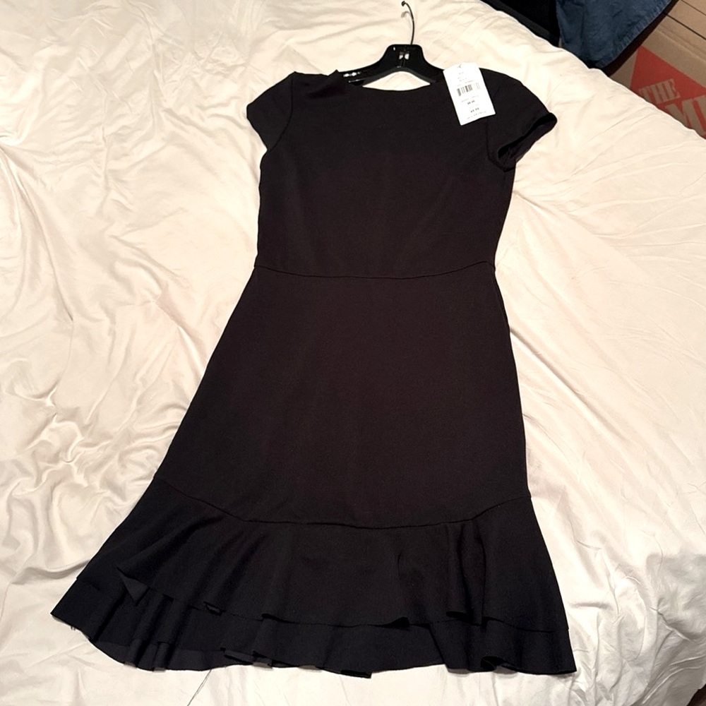Very flattering little black dress from Saks. Tags still on. Size: XS hits knee